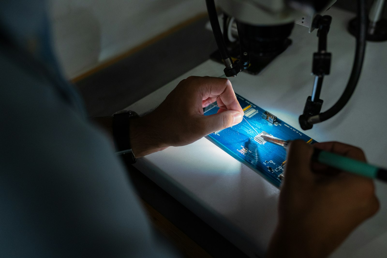 Technician repairing a circuit board